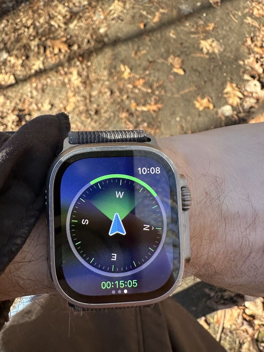Picture of the compass for the All Trails watch app. It shows an arrow with a wide green band, indicating I am heading along the correct path.